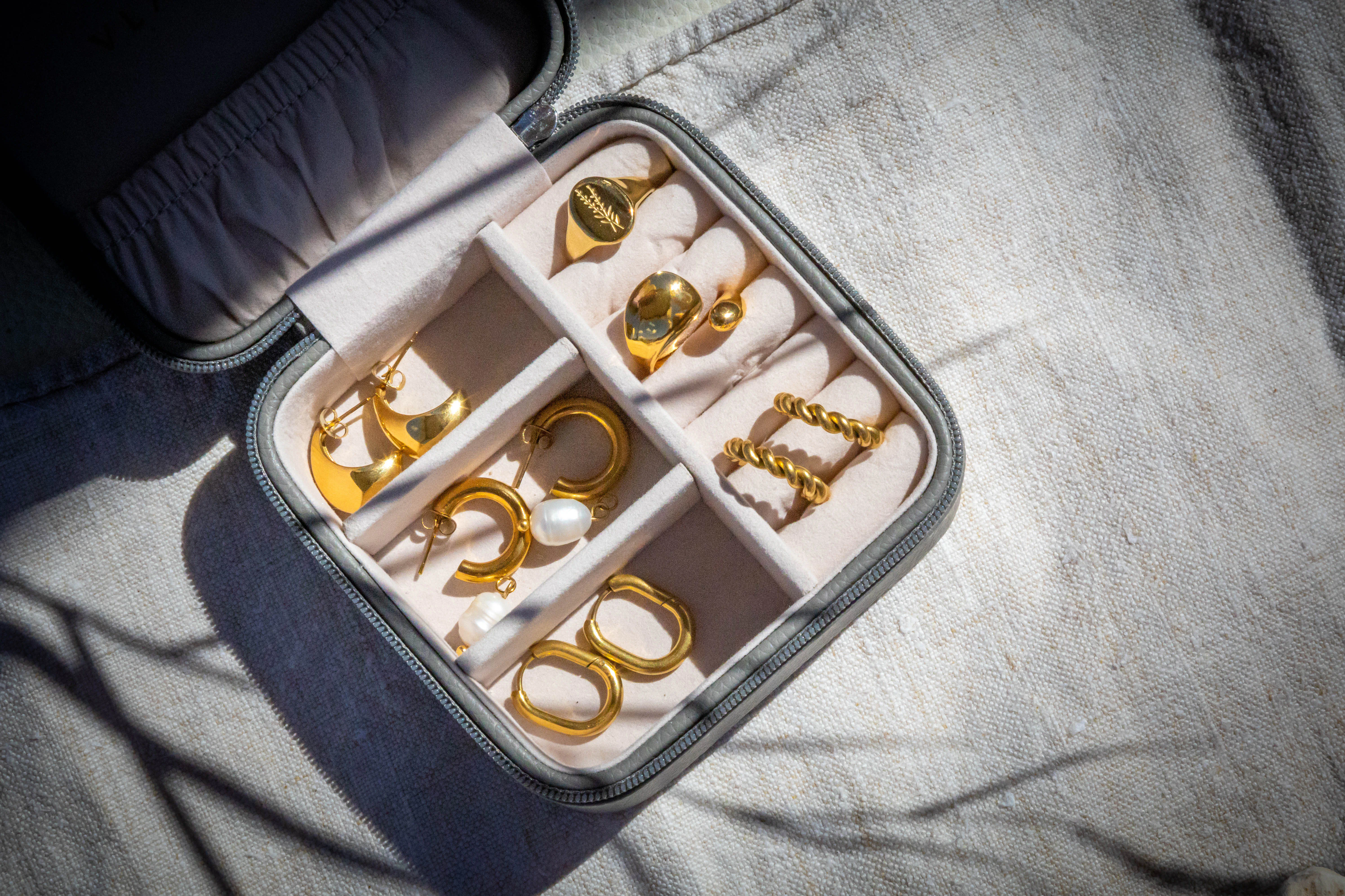 Gold jewellery arranged in a travel case